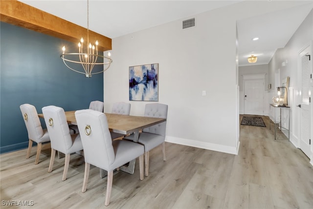 dining room featuring a notable chandelier and light hardwood / wood-style floors