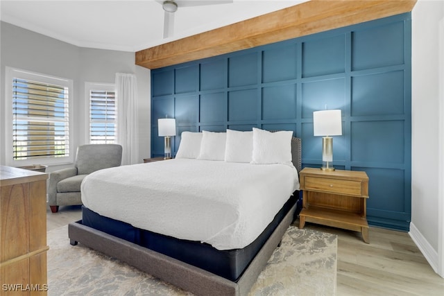 bedroom with ceiling fan, ornamental molding, and light hardwood / wood-style floors