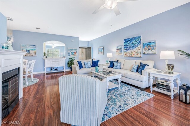 living room featuring ceiling fan and dark hardwood / wood-style floors