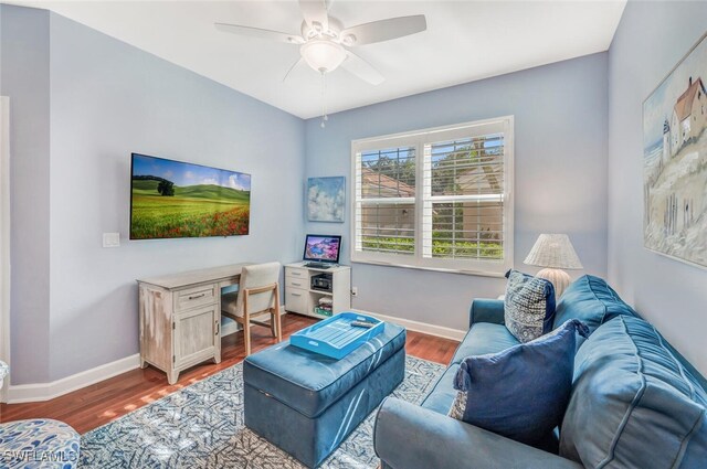 living room with wood-type flooring and ceiling fan