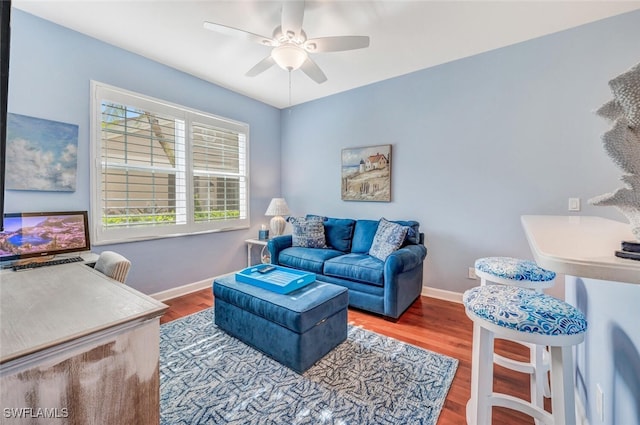 living room with wood-type flooring and ceiling fan