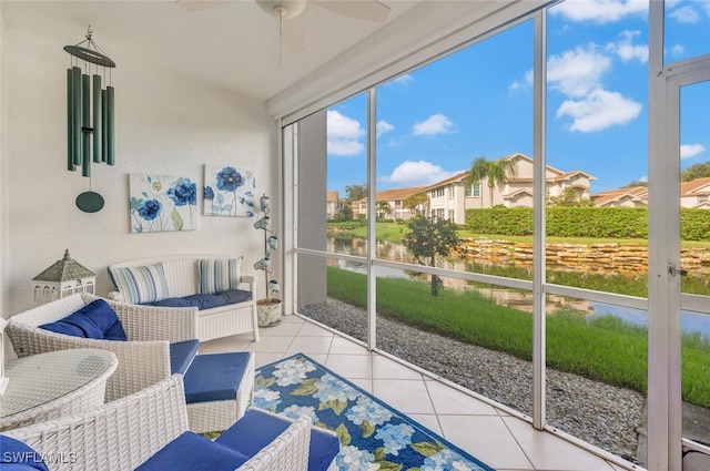 sunroom featuring ceiling fan and a residential view