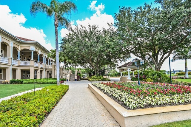 view of property's community with a yard and a gazebo