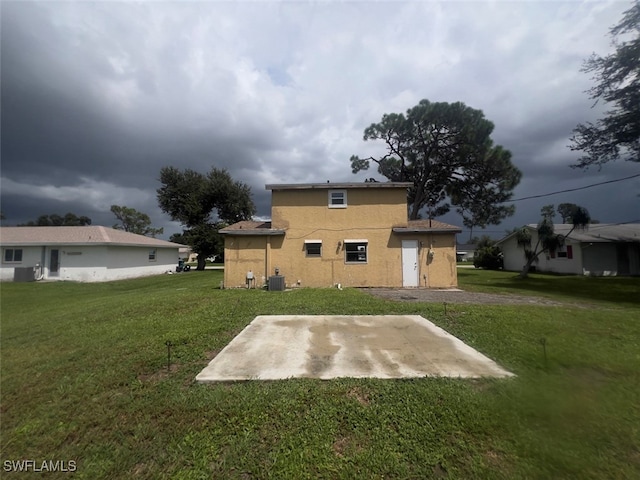 back of property featuring a patio area, a yard, and cooling unit