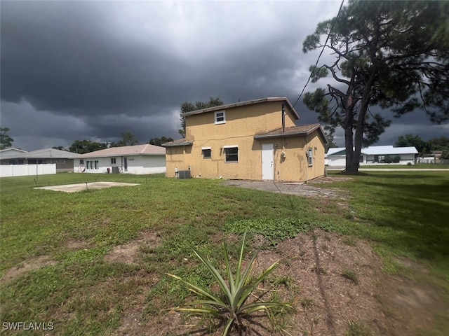 view of property exterior featuring a lawn and central AC