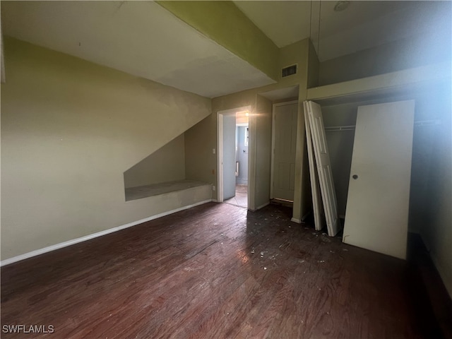 additional living space featuring lofted ceiling and dark hardwood / wood-style flooring