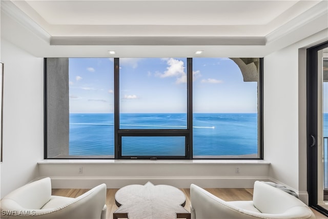 living area with a water view and hardwood / wood-style flooring