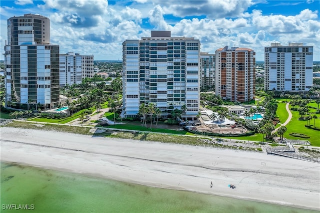 view of property featuring a beach view and a water view