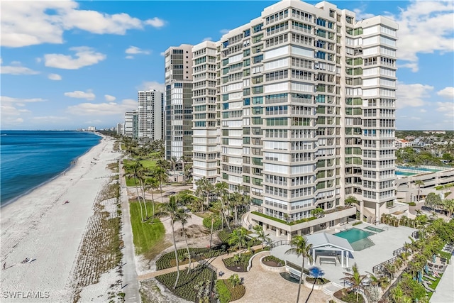 view of property with a view of the beach and a water view