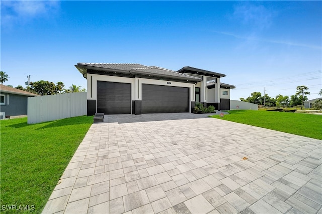 prairie-style house featuring a front yard and a garage