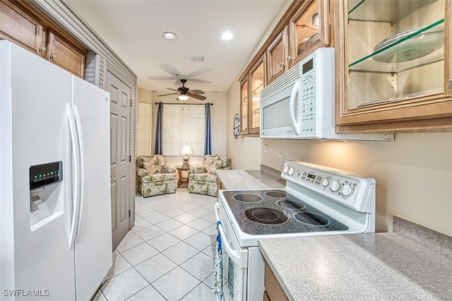 kitchen with light tile patterned floors, white appliances, and ceiling fan