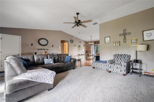 living room with carpet, ceiling fan with notable chandelier, and lofted ceiling