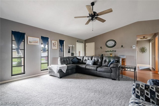 living room with carpet flooring, vaulted ceiling, and ceiling fan