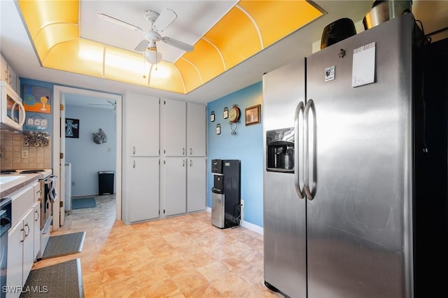 kitchen with decorative backsplash, ceiling fan, white cabinets, and stainless steel refrigerator with ice dispenser