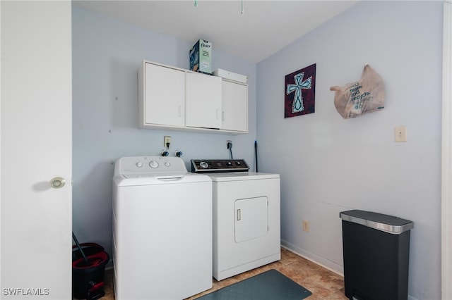 washroom featuring washer and dryer and cabinets