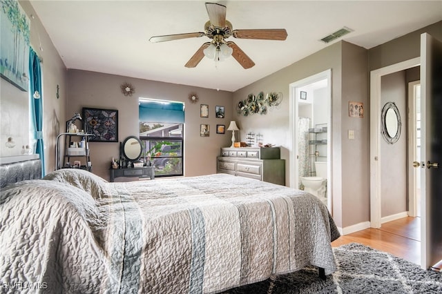 bedroom featuring connected bathroom, ceiling fan, and light hardwood / wood-style floors