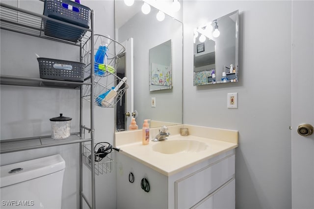 bathroom featuring vanity and toilet