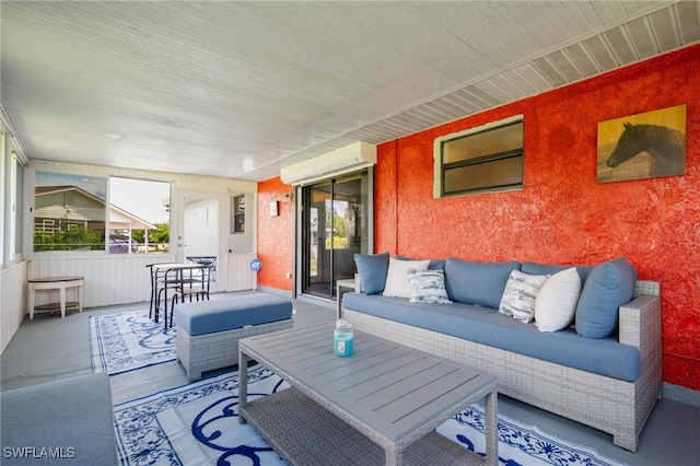 view of patio with outdoor lounge area and a wall unit AC