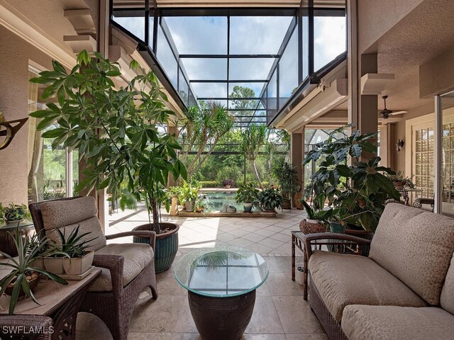 sunroom featuring ceiling fan and plenty of natural light