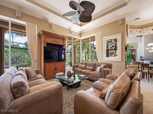 tiled living room featuring ceiling fan, a raised ceiling, and ornamental molding