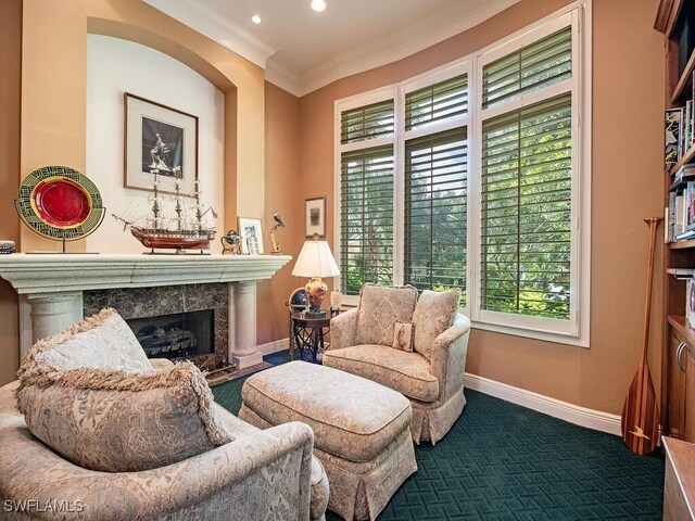 sitting room featuring dark carpet, plenty of natural light, a fireplace, and ornamental molding