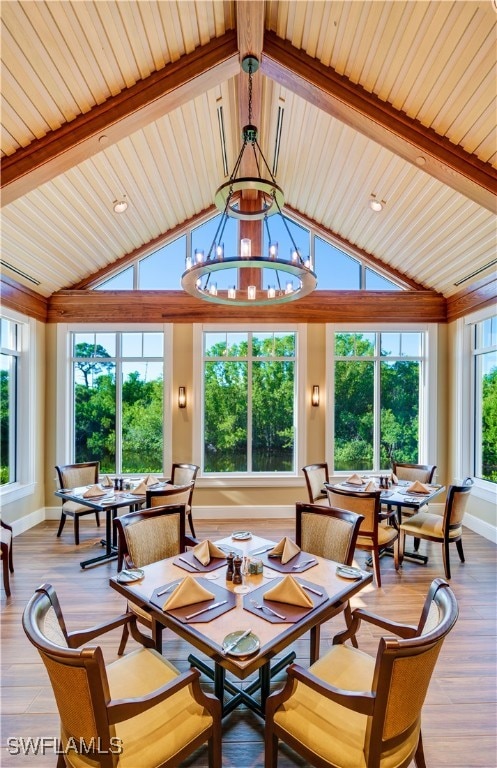 interior space with lofted ceiling with beams, hardwood / wood-style flooring, and a chandelier