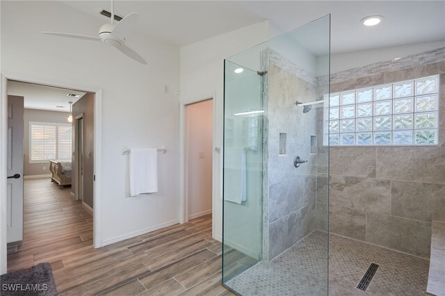 bathroom featuring ceiling fan and tiled shower