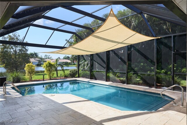 view of swimming pool featuring a lanai and a patio