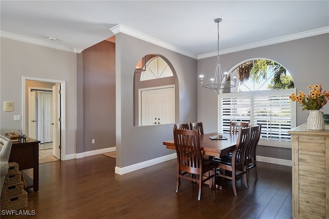 dining room featuring ornamental molding, dark hardwood / wood-style flooring, and a notable chandelier