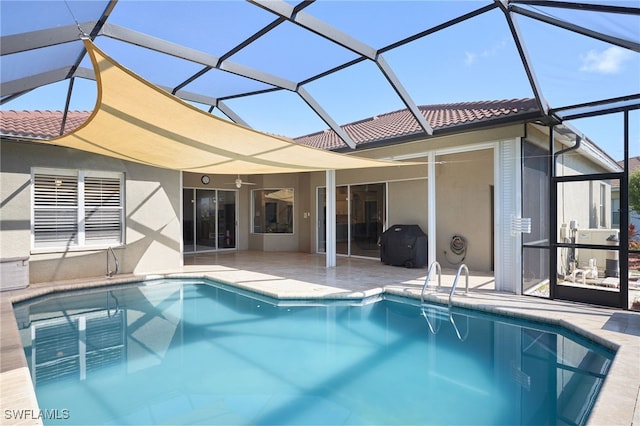 view of swimming pool with a lanai and a patio