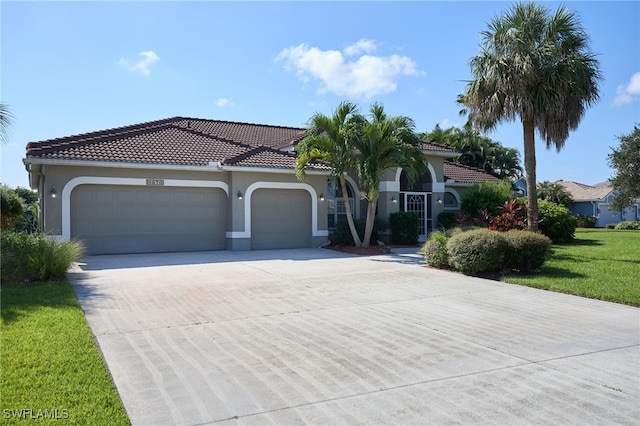 mediterranean / spanish-style house with a front lawn and a garage