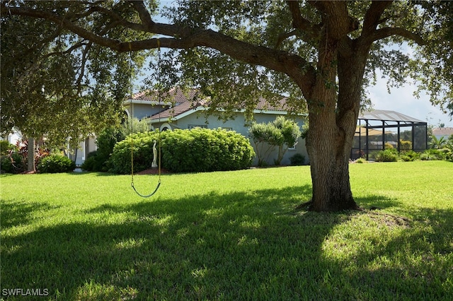 view of yard featuring glass enclosure