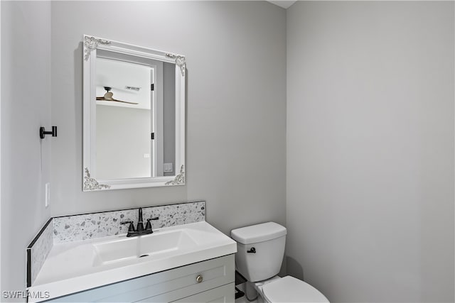 bathroom with vanity, ceiling fan, and toilet