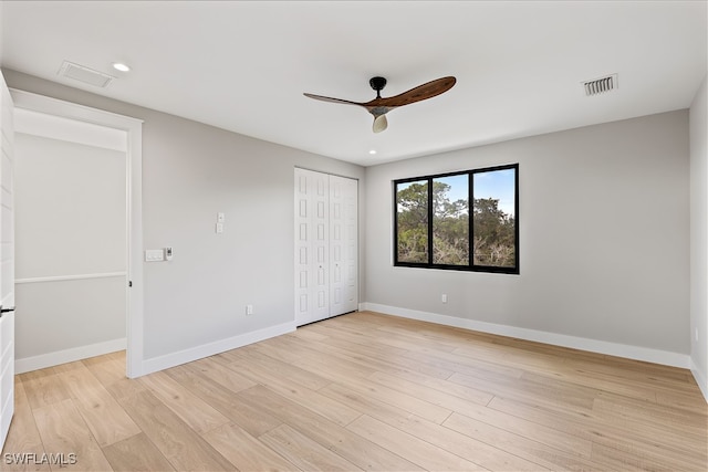 unfurnished bedroom with a closet, light hardwood / wood-style floors, and ceiling fan