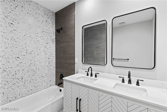 bathroom with vanity and tiled shower / bath