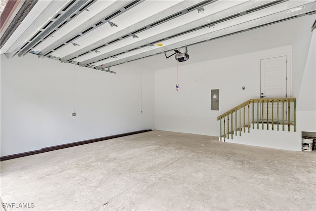 garage with electric panel and a garage door opener