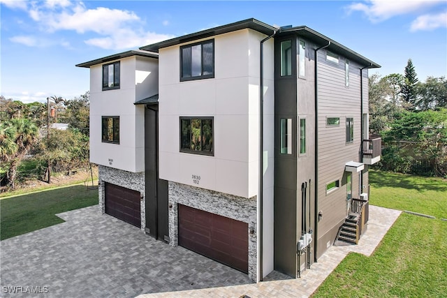 view of side of property featuring a yard and a garage