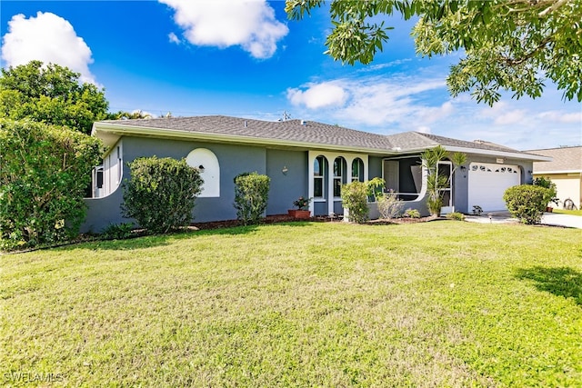 single story home with a front yard and a garage