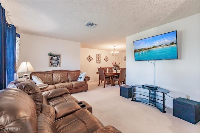 carpeted living room featuring a notable chandelier and a textured ceiling