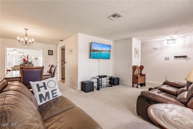 carpeted living room featuring a textured ceiling and an inviting chandelier