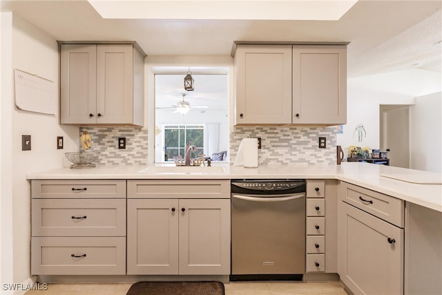 kitchen with stainless steel dishwasher, decorative backsplash, ceiling fan, gray cabinets, and sink