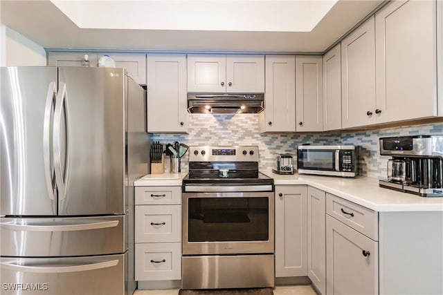 kitchen featuring range hood, stainless steel appliances, and decorative backsplash