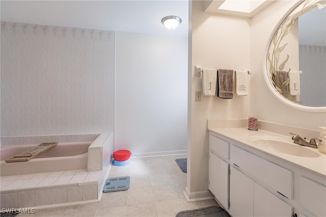 bathroom with tile patterned floors, a skylight, and vanity