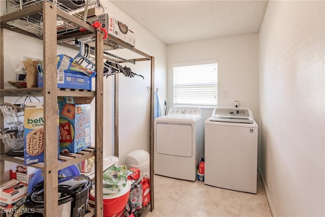 laundry area featuring washer and dryer and a textured ceiling