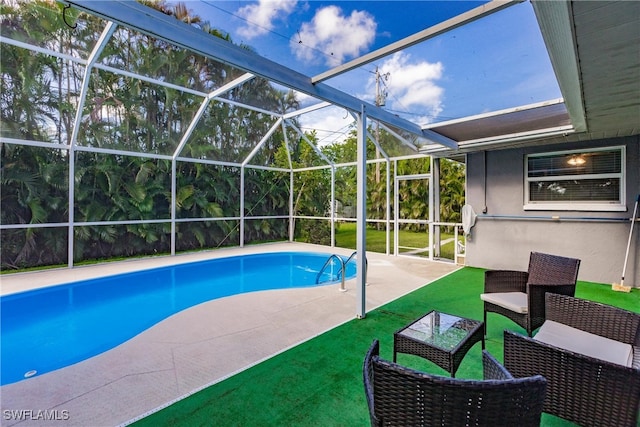 view of swimming pool with a yard, a lanai, a patio area, and outdoor lounge area