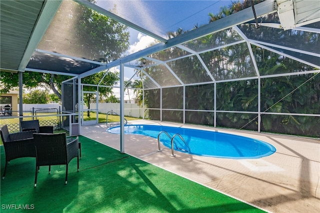 view of pool featuring a patio, a lawn, and a lanai