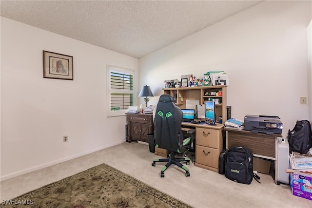 office with light colored carpet, vaulted ceiling, and a textured ceiling