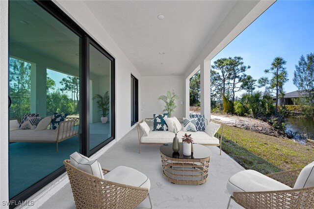 view of patio with an outdoor hangout area and a water view