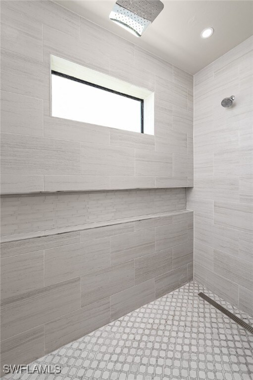 bathroom with a tile shower