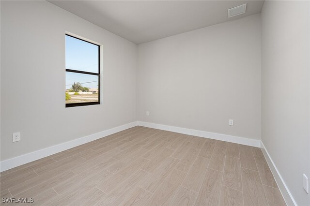 spare room with light hardwood / wood-style floors